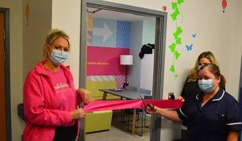 A photo of two NHS staff members and a Candlelighters staff member doing the ribbon cut for the new staff space.