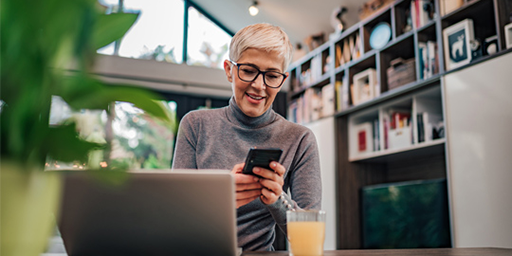 Person checking their phone in a home office.
