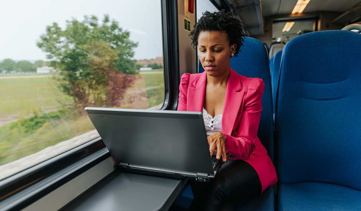 Woman working remotely on a train